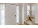 Inviting entryway featuring a white front door, natural light, and staircase access to the home's upper level at 3157 Peartree Nw Dr, Acworth, GA 30101