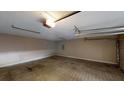 Spacious two-car garage featuring a clean concrete floor and ample room for parking and storage at 3157 Peartree Nw Dr, Acworth, GA 30101