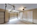 Two-car garage with a door to the home featuring a clean concrete floor and ample room for parking at 3157 Peartree Nw Dr, Acworth, GA 30101