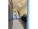 Inviting entryway with wood floors, elegant light fixture, and decor at 544 Magnolia Circle, Palmetto, GA 30268