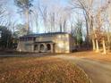 Two-story home featuring a charming front entry, nestled among mature trees and a winding driveway at 110 Chippewa Ct, Riverdale, GA 30296