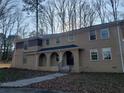 Charming two-story home featuring arched entryway, complemented by a beautiful wooded backdrop at 110 Chippewa Ct, Riverdale, GA 30296