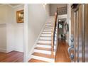 Inviting home foyer featuring hardwood floors, staircase, and a view into the living spaces, creating a warm welcome at 1549 Lake Holcomb Ln, Marietta, GA 30062