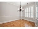 Bright and airy room featuring hardwood floors, white shutters, and a classic chandelier, creating a sophisticated ambiance at 1549 Lake Holcomb Ln, Marietta, GA 30062