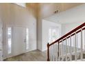 Bright entryway with wood-look flooring, a white front door, and a staircase with wood handrail at 3001 Donamire Nw Ave, Kennesaw, GA 30144