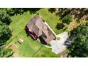 Aerial shot of a beautiful brown roof home and concrete driveway surrounded by greenery at 6945 John Rivers Rd, Fairburn, GA 30213