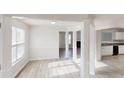Bright living room with modern gray floors, white trim, and an open layout at 1001 Balsam Wood Trl, Villa Rica, GA 30180
