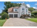 Elegant two-story home featuring a spacious driveway and attached two-car garage at 1430 Grovehurst Dr, Marietta, GA 30062