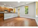Open living space with hardwood floors, a breakfast bar, stainless steel appliances, and a bright window at 5933 Brookside Oak Cir, Norcross, GA 30093