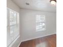 Bright bedroom featuring hardwood floors, fresh paint, and natural light from two windows at 71 Thayer Se Ave, Atlanta, GA 30315