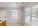 Bright kitchenette with window, vinyl floors, and pendant light fixtures at 71 Thayer Se Ave, Atlanta, GA 30315