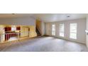Spacious living room with ample natural light, featuring an open floor plan with seamless access to the kitchen at 1169 Oaks Pl, Stone Mountain, GA 30083