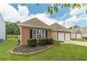 Well-maintained brick home featuring black shutters and manicured landscaping at 2895 Dominion Walk Ln, Snellville, GA 30078