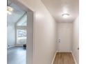 Hallway view leading to a sunlit living room with light hardwood floors at 366 O Brian Dr, Stone Mountain, GA 30088