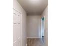A hallway with a white door, light colored walls and hardwood floors at 366 O Brian Dr, Stone Mountain, GA 30088