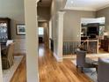 Spacious hallway with hardwood floors, columns, and views into the dining and living spaces at 605 Meadows Creek Dr, Johns Creek, GA 30005