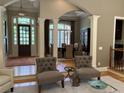 Inviting living space with stylish furnishings, columns, and an open view to the dining area at 605 Meadows Creek Dr, Johns Creek, GA 30005