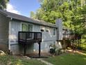 Exterior of home with multiple decks overlooking a wooded backyard at 1701 Charmeth Rd, Lithonia, GA 30058