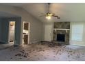 Open living room with a stone fireplace and a view of the kitchen at 1701 Charmeth Rd, Lithonia, GA 30058