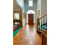 Bright foyer with hardwood floors, high ceilings, and staircase with a wooden railing at 4715 Scotney Ct, Suwanee, GA 30024