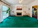 Bright living room with built-in shelving, a stone fireplace, and large windows at 4715 Scotney Ct, Suwanee, GA 30024