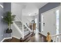 Inviting foyer with hardwood floors, gray walls, and a staircase with white banister at 8690 Cedar Creek Rdg, Riverdale, GA 30274