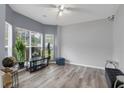 Bright living room featuring stylish gray floors, large windows, and modern decor at 8690 Cedar Creek Rdg, Riverdale, GA 30274