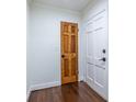 A classic hallway featuring two doors and dark hardwood floors at 1393 Sagewood Cir, Stone Mountain, GA 30083