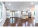 Open-concept living area with hardwood floors, built-in bookshelves, and abundant natural light at 1393 Sagewood Cir, Stone Mountain, GA 30083