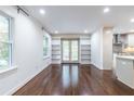 Bright living room with hardwood floors, built-in bookshelves, and large windows at 1393 Sagewood Cir, Stone Mountain, GA 30083