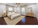 Serene main bedroom with neutral decor, plush bedding, hardwood floors, and natural lighting at 1393 Sagewood Cir, Stone Mountain, GA 30083