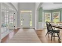 Bright foyer with high ceilings, hardwood floors, and a front door with sidelights and transom window at 2045 Barrett Downs Dr, Cumming, GA 30040