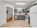 Functional kitchen featuring stainless steel appliances, grey cabinets, and tile floors at 3073 Waldrop Cir, Decatur, GA 30034