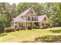 Beautiful two-story home with a well-maintained lawn and mature trees at 5581 Fox Glove Ct, Douglasville, GA 30135