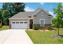 Inviting home featuring a well-kept lawn and a convenient two-car garage at 7301 Cranleigh St, Covington, GA 30014