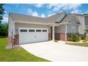 Attractive single-story home with a two-car garage and lush green grass at 7301 Cranleigh St, Covington, GA 30014
