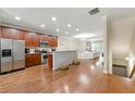 Open-concept kitchen with stainless steel appliances, wooden cabinets, and a breakfast bar at 3642 Princeton Ave, Atlanta, GA 30337