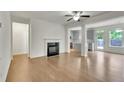 Open living room layout with hardwood floors, a fireplace, and access to the kitchen at 5312 Brooklands Dr, Lithonia, GA 30058