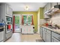 Kitchen features stainless appliances, granite countertops, and access to the deck at 144 Boones Ridge Se Pkwy, Acworth, GA 30102
