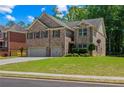 Charming two-story home with brick facade, manicured lawn and two car garage at 2015 Chapel Estates Lane Southeast Ln, Dacula, GA 30019