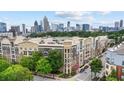 This aerial view showcases the complex with city views and beautiful landscaping at 390 17Th Nw St # 4031, Atlanta, GA 30363