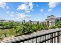 Features a street view from a balcony, with trees, a river and the Atlanta History Center in the background at 390 17Th Nw St # 4031, Atlanta, GA 30363