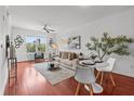 Bright living room with hardwood floors, neutral decor, and a large window showcasing exterior greenery at 390 17Th Nw St # 4031, Atlanta, GA 30363