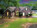Charming brick home featuring a manicured lawn and mature landscaping, creating a welcoming curb appeal at 401 Crosshaven Way, Mcdonough, GA 30253