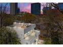 Modern home with rooftop deck, views, and private setting surrounded by trees within view of the city skyline at 1231 Barnes Nw St, Atlanta, GA 30318