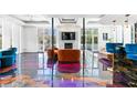Bright living room featuring fireplace, artistic epoxy floors and large windows overlooking the exterior at 1231 Barnes Nw St, Atlanta, GA 30318