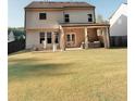 Spacious backyard featuring a covered patio with seating and an expansive lawn at 126 Jacobs Ln, Loganville, GA 30052
