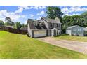 Two-story home featuring a two-car garage and well-kept front lawn at 625 Hickory Nobb, Sugar Hill, GA 30518