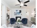 Living room boasts a ceiling fan, fireplace, and modern furnishings with blue accent pieces at 2453 Honey Way, Conyers, GA 30013