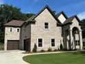 Elegant brick residence showcasing a symmetrical facade and lush landscaping at 2571 Se Ebenezer Rd, Conyers, GA 30094